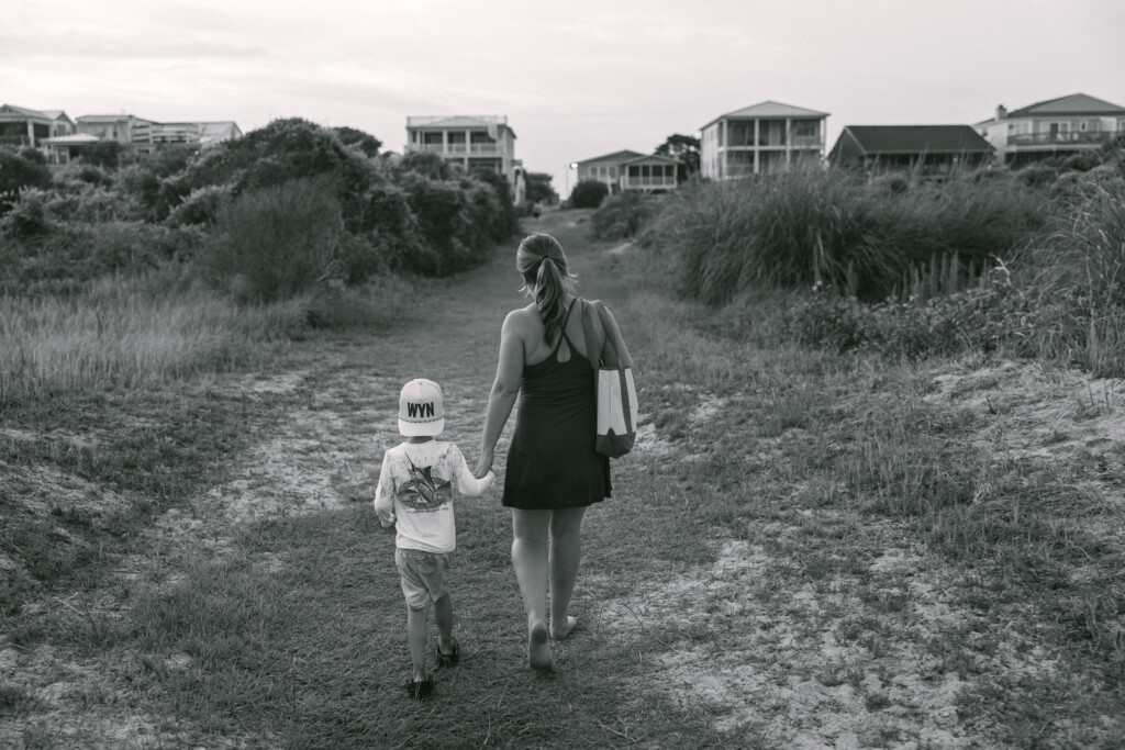 Candid beach portrait with soft tones, focusing on connection and coastal beauty.