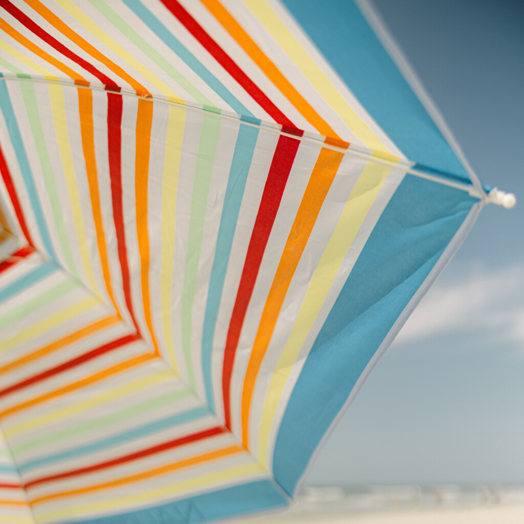 Candid beach portrait with soft tones, focusing on connection and coastal beauty.