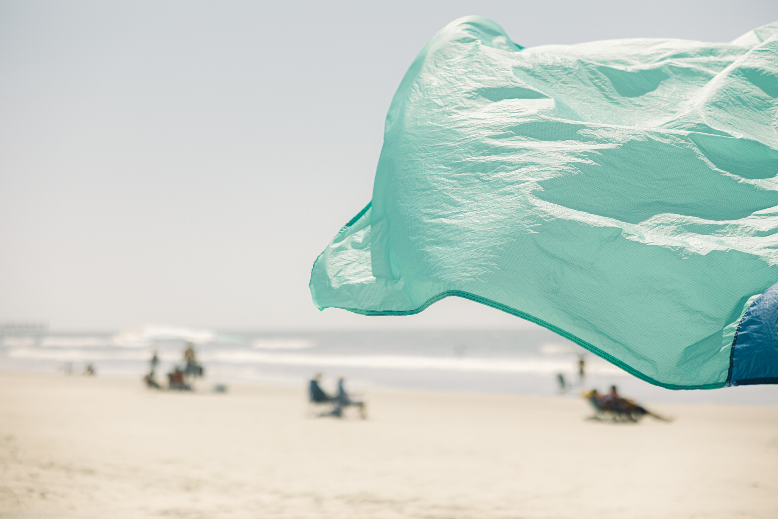 Candid beach portrait with soft tones, focusing on connection and coastal beauty.