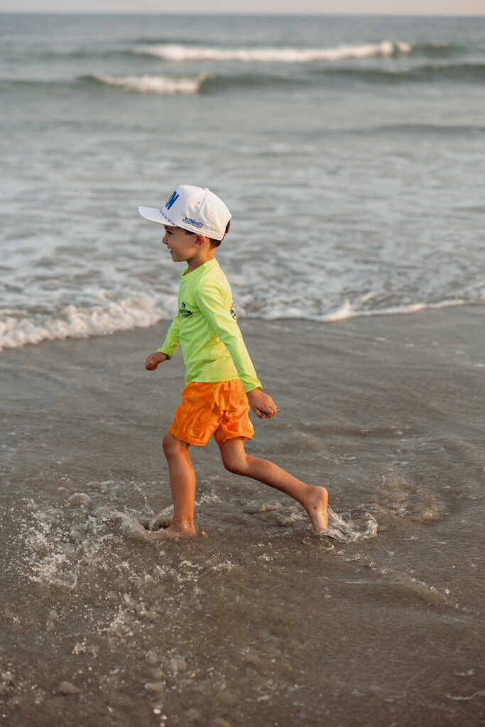 Candid beach portrait with soft tones, focusing on connection and coastal beauty.