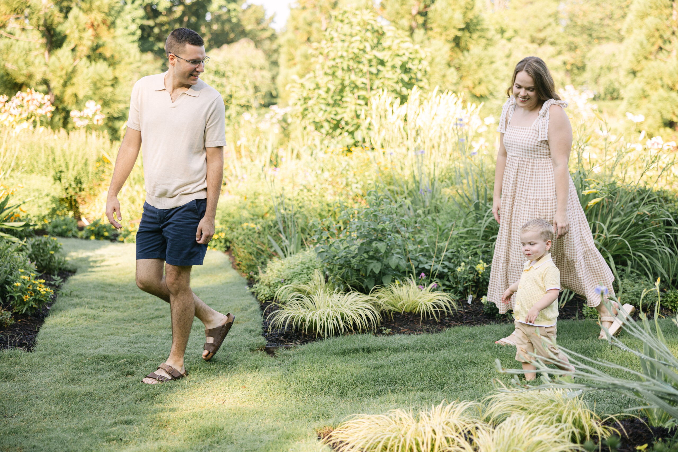 Family walking together through Reynolda Gardens during golden hour in Winston-Salem, NC