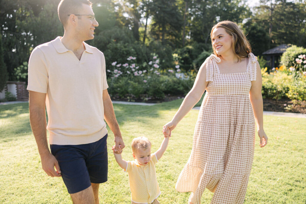 Family walking together through Reynolda Gardens during golden hour in Winston-Salem, NC