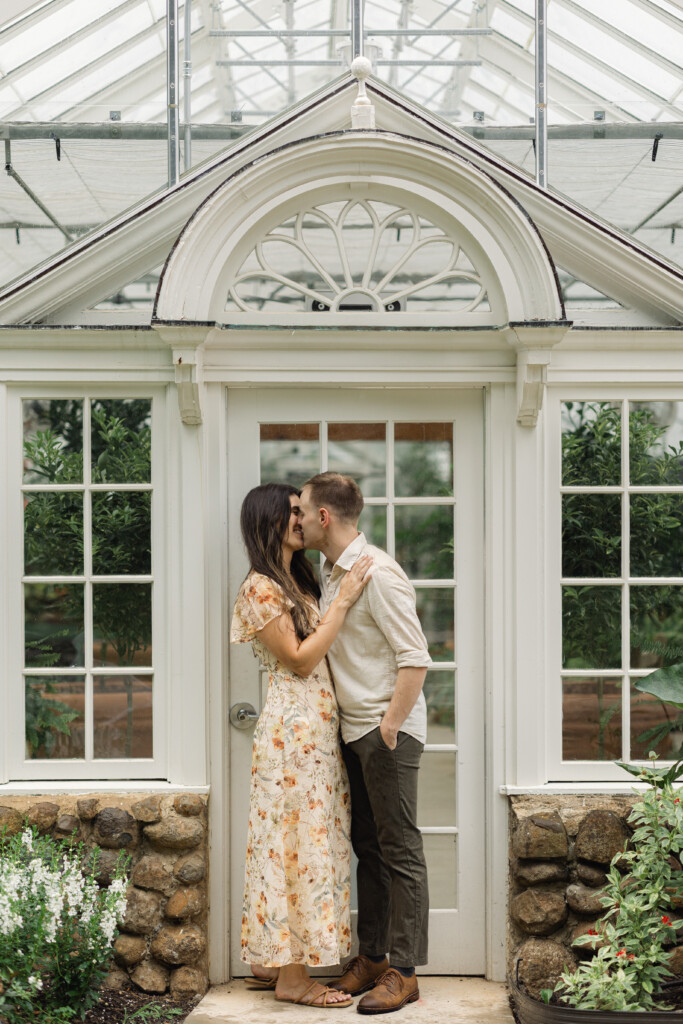 Engaged couple sharing a romantic moment in Reynolda Gardens