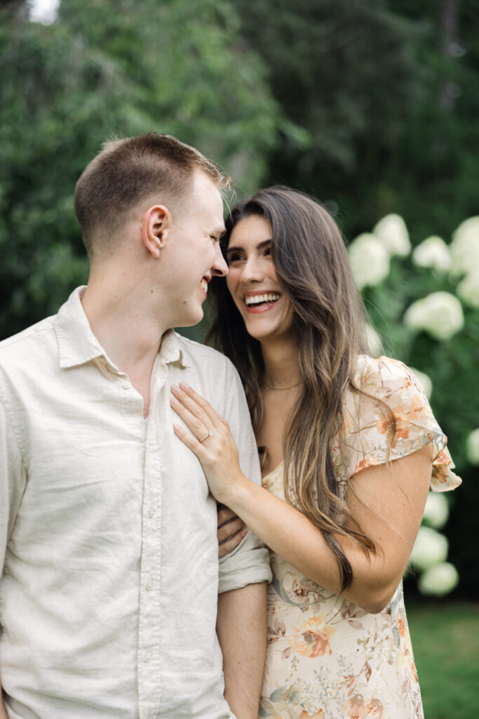 Engaged couple sharing a romantic moment in Reynolda Gardens