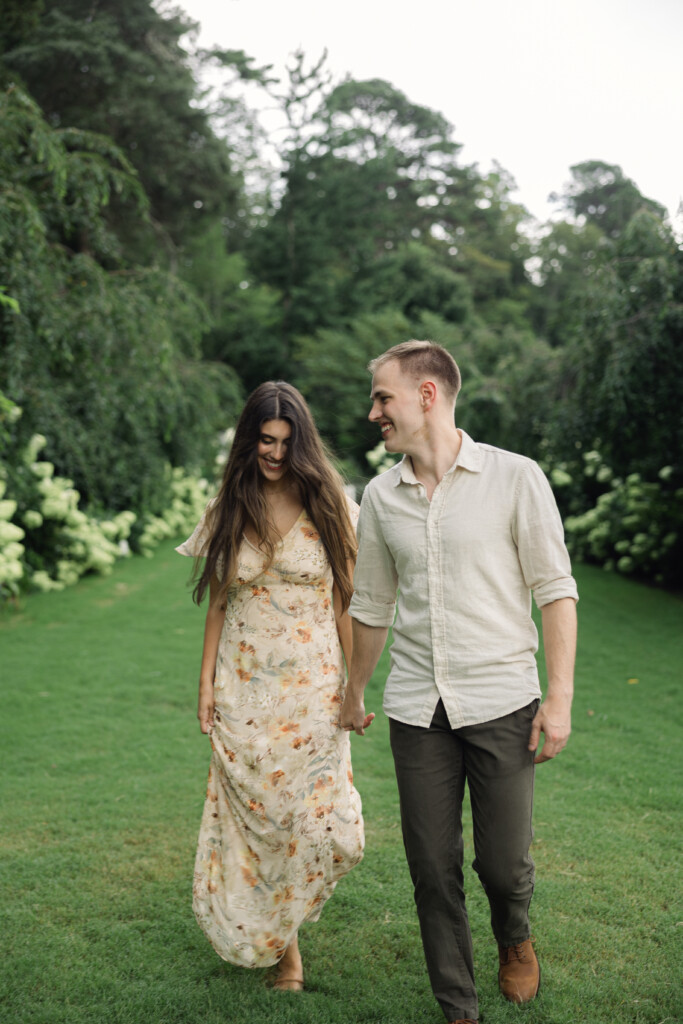 Engaged couple sharing a romantic moment in Reynolda Gardens