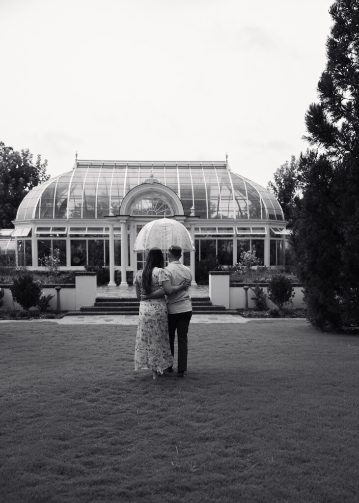 Engaged couple sharing a romantic moment in Reynolda Gardens