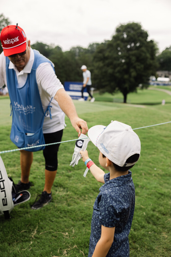 Young fan gets golf glove from caddy at Wyndham Championship in Greensboro, NC
