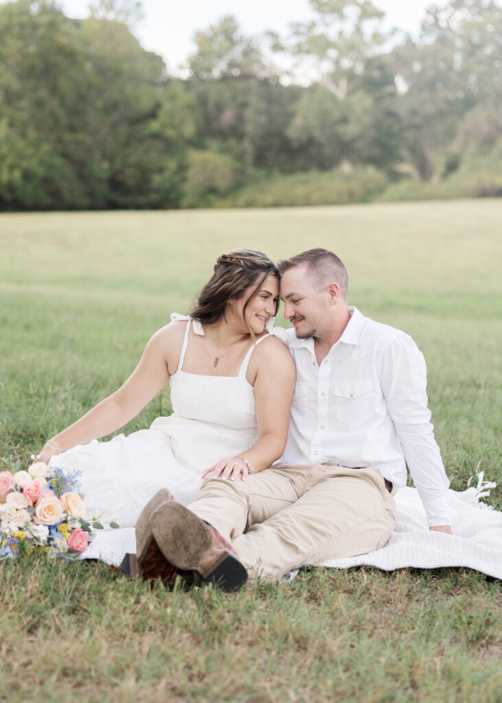 Engaged couple embracing in open field, North Carolina engagement photography