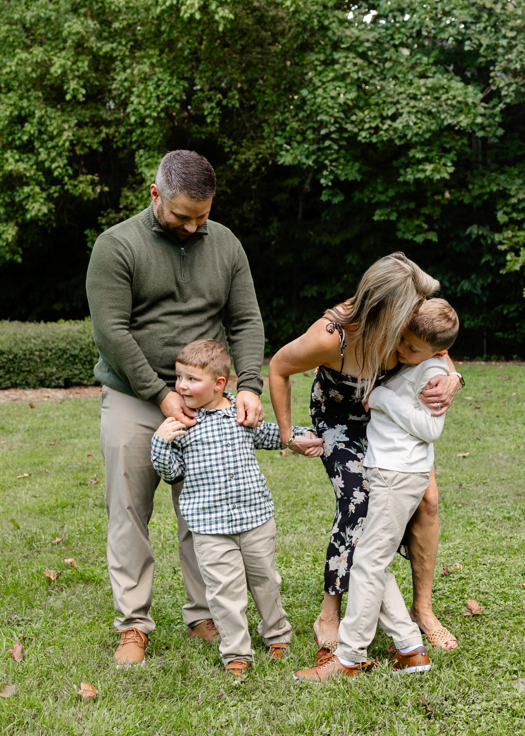 Sensory-friendly family photographer capturing siblings playing together in a quiet Greensboro park
