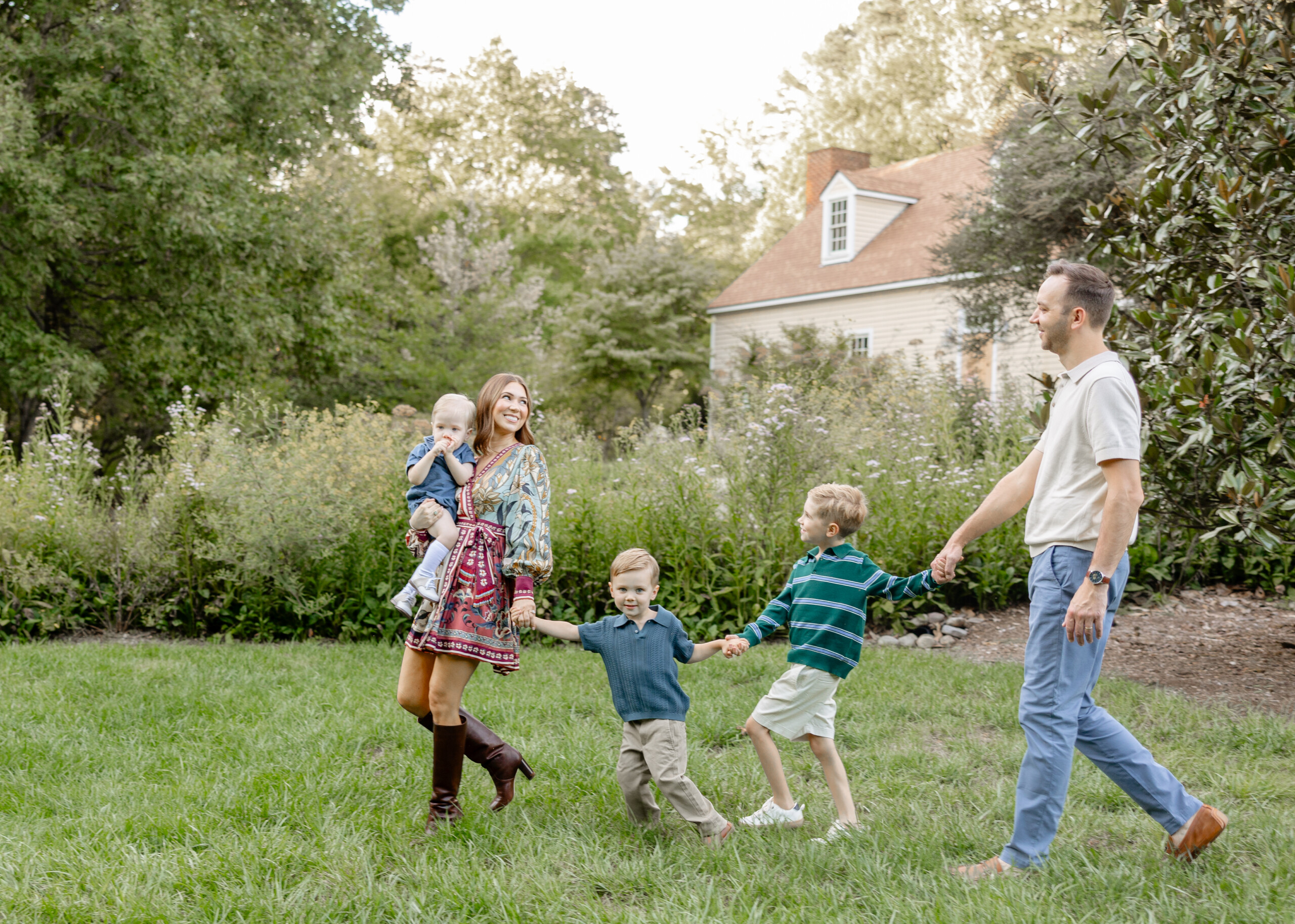 Family laughing together during fall photo session in Greensboro, NC